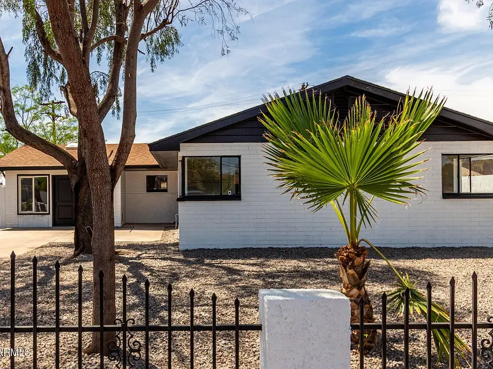 White block home with black trim at 3802 N 48th Dr after the repaint